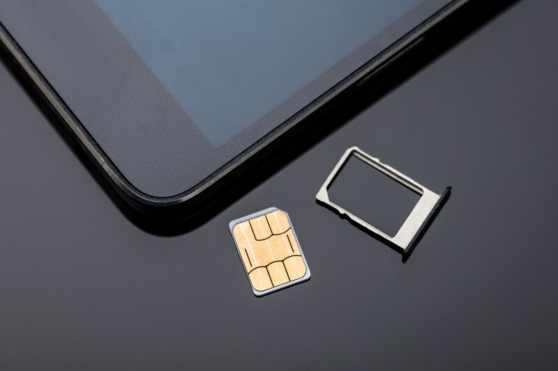 nano sim ready to be inserted into smartphone