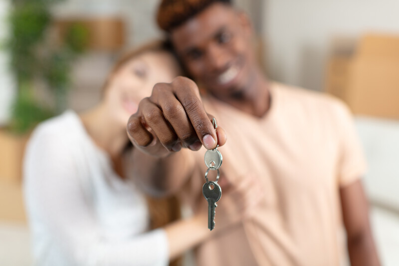young couple with keys to new house